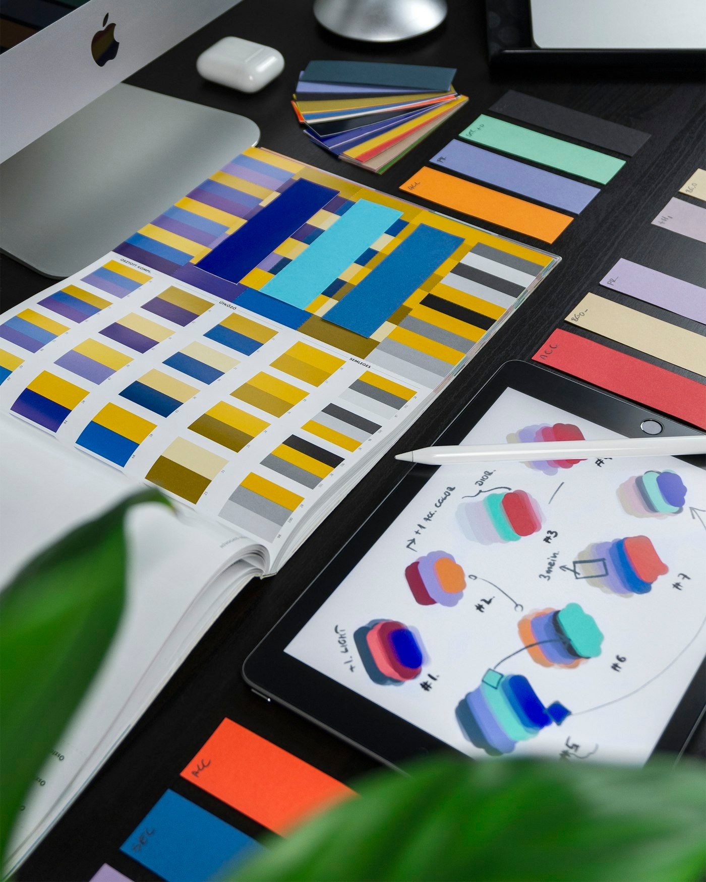 Brand colour palettes and design drafts on a studio desk