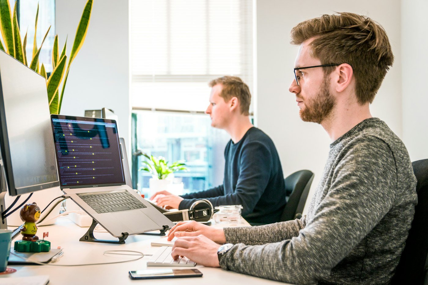 Two developers reviewing a website build together at their desks